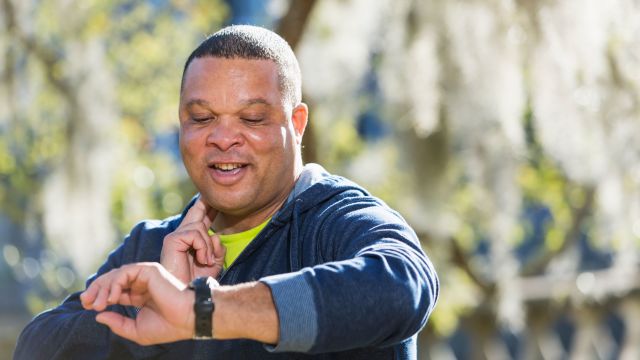 mature man taking pulse