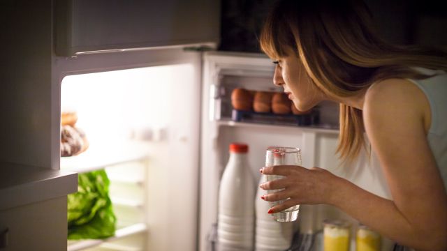 woman looking in fridge