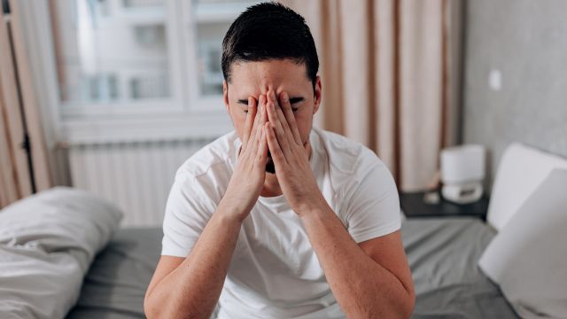 man holding his nose