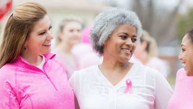 Women wearing pink ribbons for breast cancer awareness