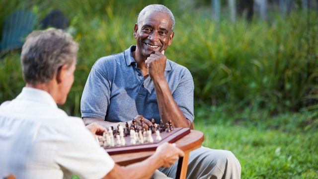 senior man playing chess