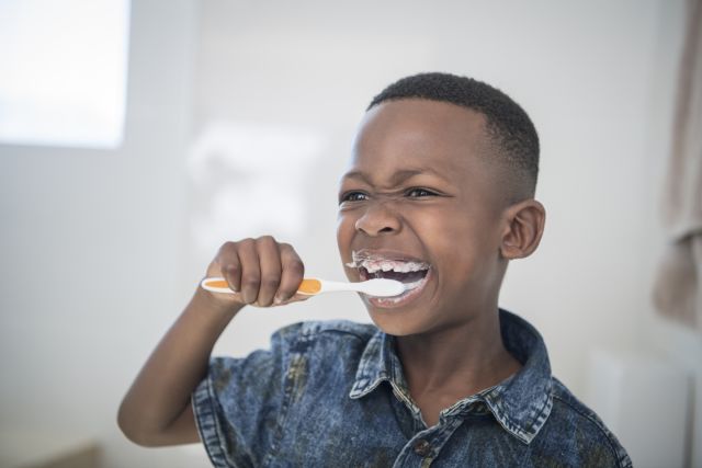 boy brushing his teeth