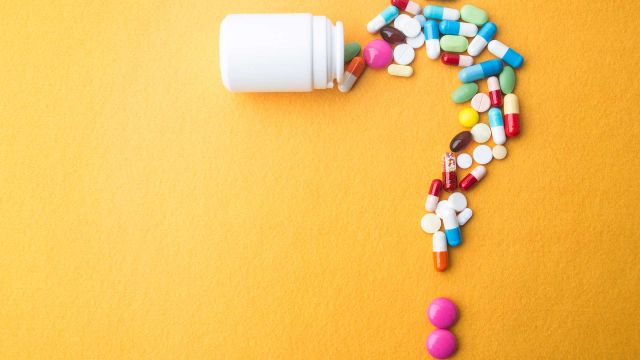white pills on a sheet of paper with "calcium" written in the middle