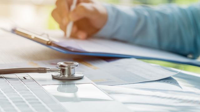 doctor filling out paperwork