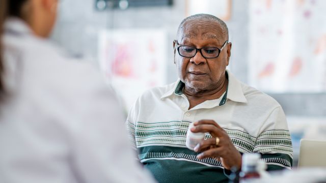 man holding pill bottle