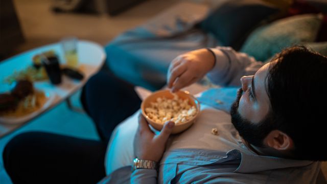 man eating popcorn