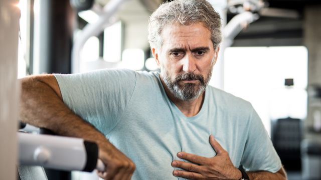 man holding chest