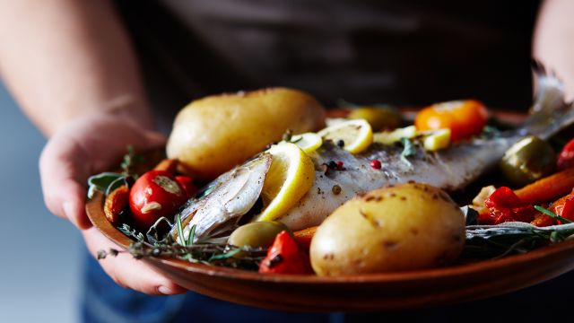 A platter of fish and vegetables. 