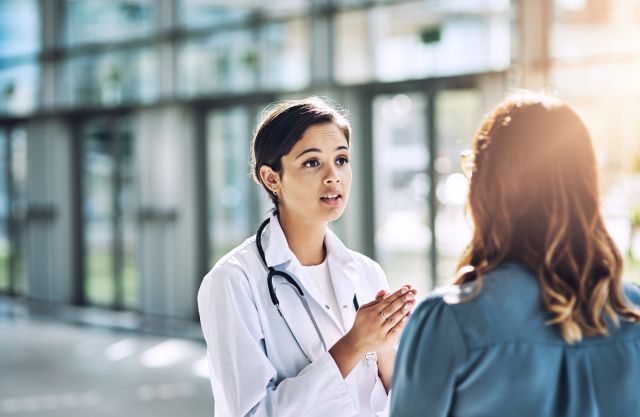 A young woman talks with her surgeon. Some women will require surgery to treat endometriosis.