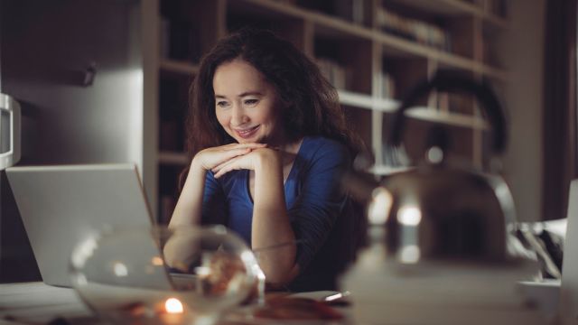 smiling woman working on laptop