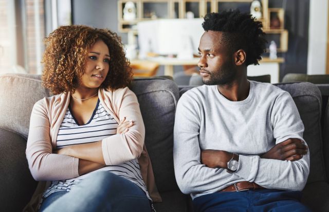 couple having discussion on sofa