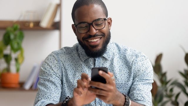 man smiling with phone