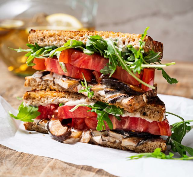 Vegetarian sandwich made with mushrooms, lettuce and tomato
