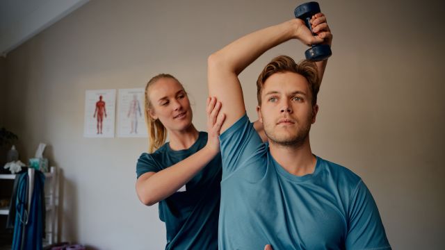 Young man getting physical therapy for ankylosing spondylitis.