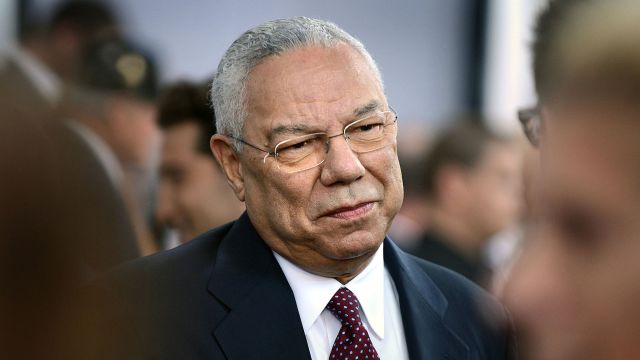 Colin Powell smiling at something off-camera