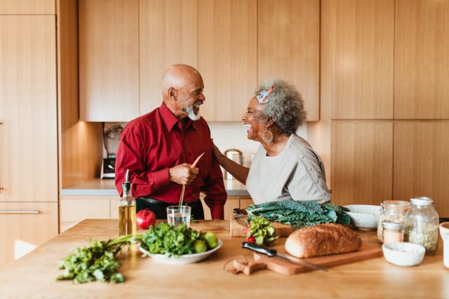 older couple cooking dinner