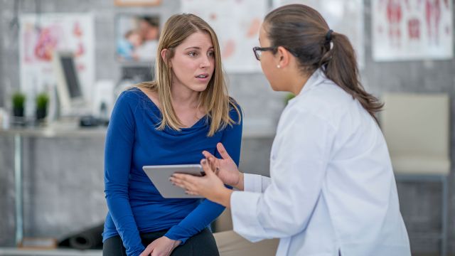 Doctor discussing treatment with female patient.