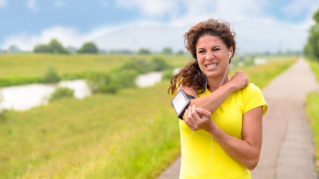An exercising woman stops to rub where an RA flare up occurred. What causes rheumatoid arthritis flare ups?