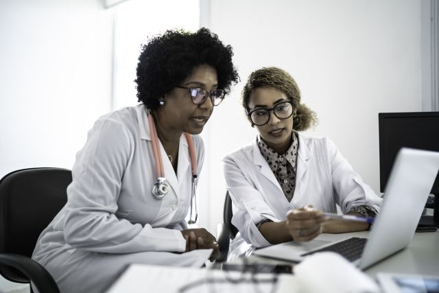 female doctors at laptop discussing