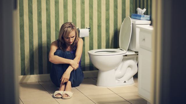 A young woman struggles with constipation. CIC and IBS-C are functional GI disorder that can cause chronic constipation.