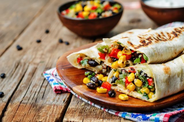 Healthy veggie burritos with corn, beans, peppers, and quinoa