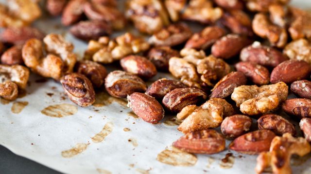 Spiced nuts spread out over a countertop.