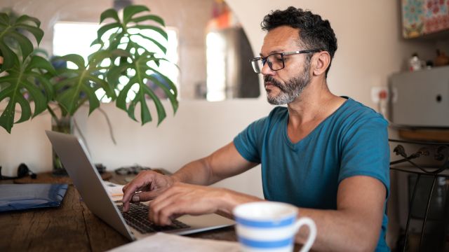 man with glasses using laptop