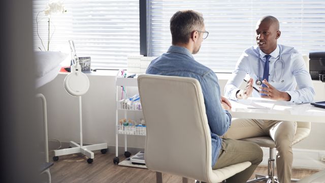 An HIV patient talks to his healthcare provider.