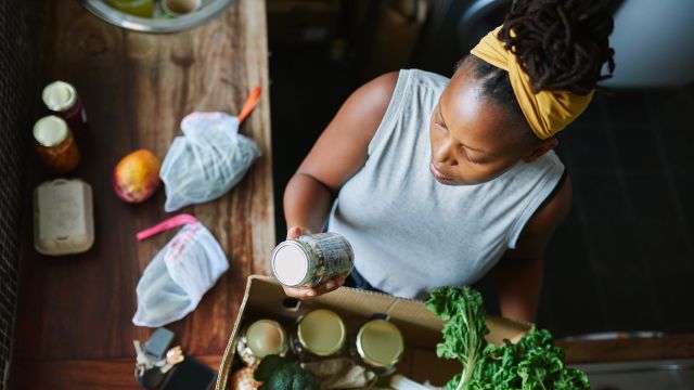 Young woman unpacking healthy groceries.