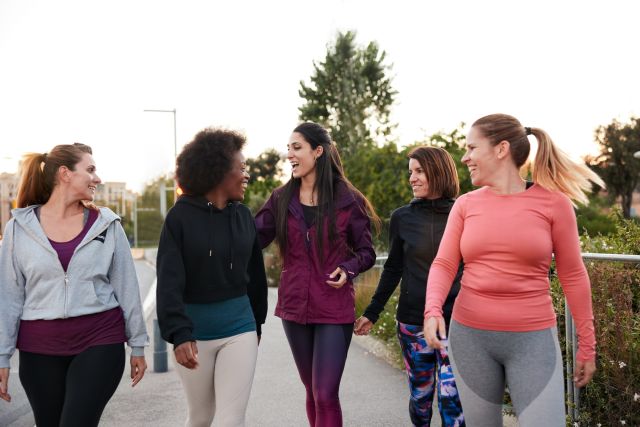 group of women friends walking for exercise