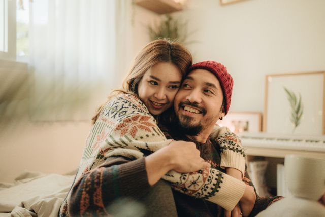 Happy young couple at home hugging