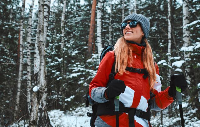 a woman skiing wearing sunglasses