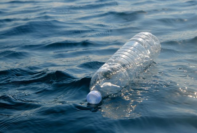 empty plastic water bottle floating in ocean