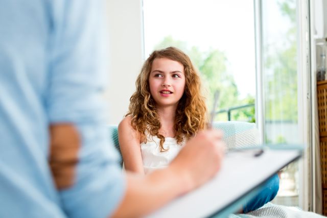 Preteen girl talking with therapist 