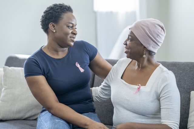 woman comforts friend with breast cancer
