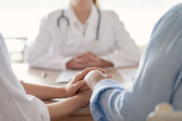 Woman with cancer and her male partner sit at the desk of a fertility doctor to discuss goserelin therapy.