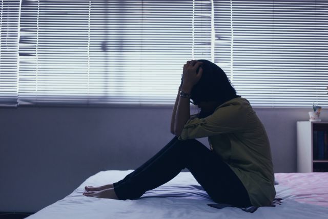A woman with bipolar disorder sits alone in a bedroom. Untreated bipolar disorder can become more severe, disrupting relationships and many other aspects of a person's life.