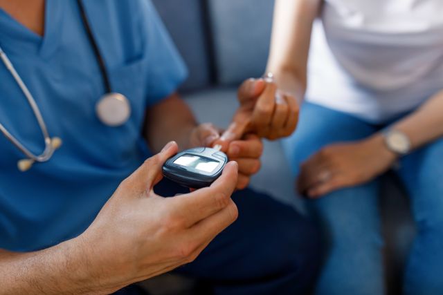 patient receiving a1c diabetes test from doctor