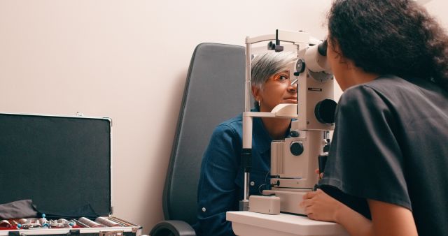 An eye doctor examines a woman's eye during an appointment. A good understanding of how diabetes can affect the eyes can be helpful when working with a healthcare provider. 