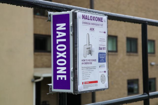 a public access naloxone distribution station located in a city