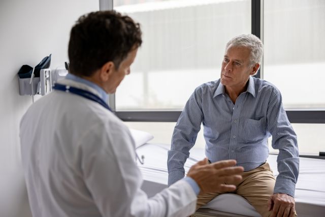 a middle aged white man speaks to his doctor about risk factors for Parkinson's disease