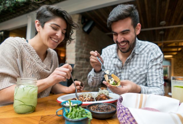 a happy couple enjoys dinner at an open-air Mexican restaurant