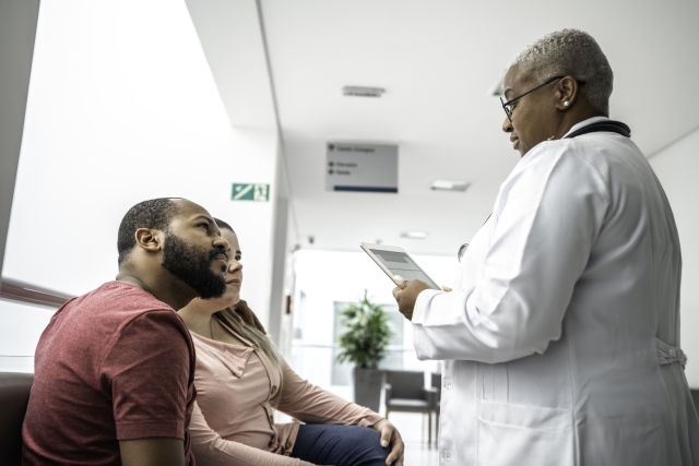 couple talking to hospital doctor