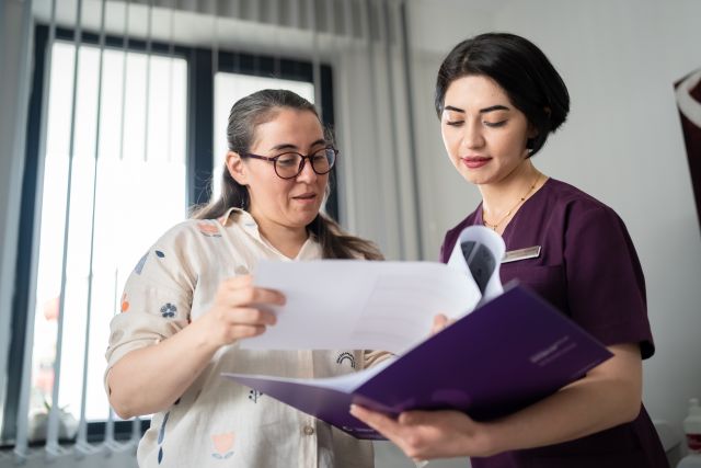 healthcare providers reviewing medical records in folder