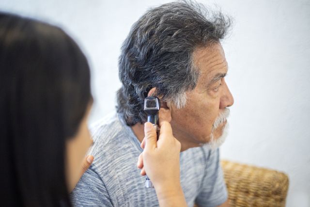 mature man having his hearing checked by a healthcare provider