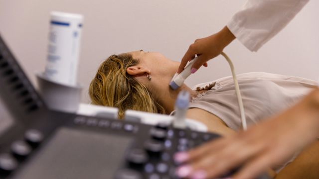 A woman has her thyroid gland examined with an ultrasound during an appointment with her healthcare provider. The most common cause of thyroid eye disease is Graves' disease, an autoimmune disorder that affects the thyroid gland.