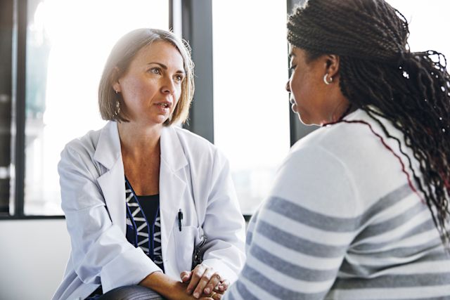 young adult female talking with healthcare provider