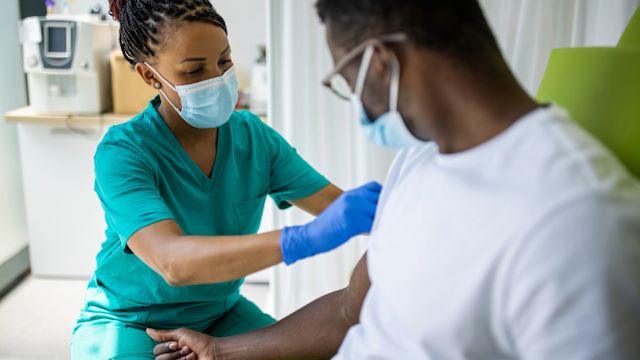 A man receives a blood transfusion at a healthcare provider's office as part of treatment for sickle cell disease.
