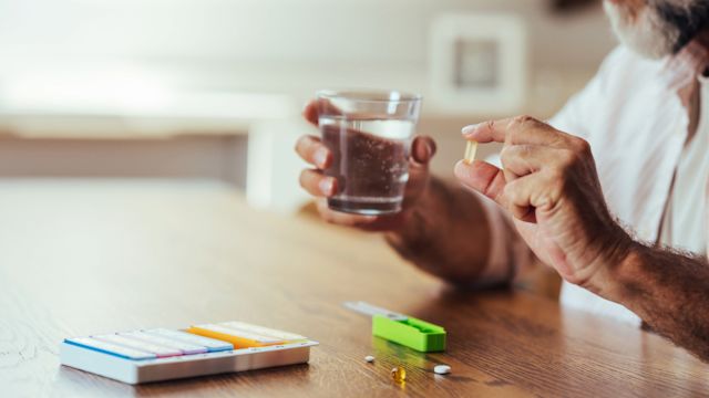 A senior man uses a pill organizer to plan out his medications for the days and weeks ahead. Treating cancer with an oral medication requires more organization and responsibility, and it helps to employ strategies to set yourself up for success.