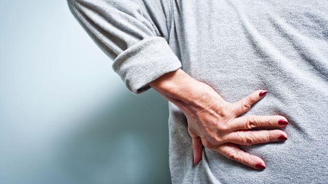 Senior woman experiencing lower back pain